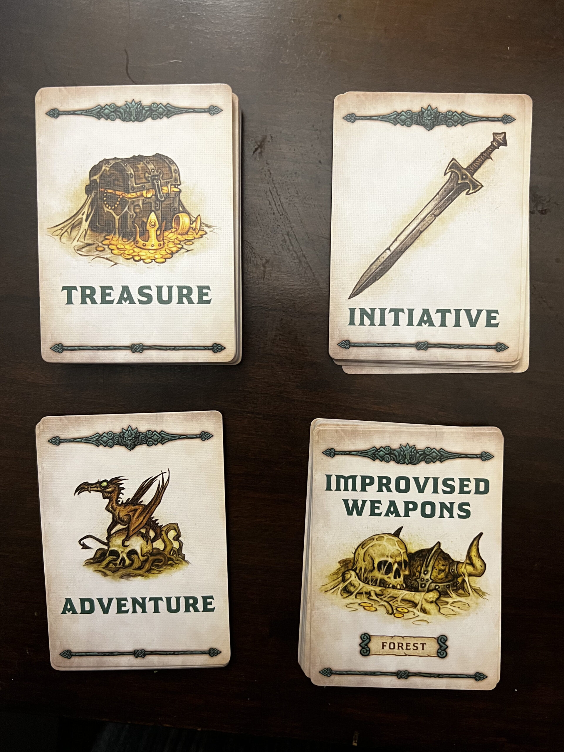 Image of Dragonbane treasure, initiative, adventure, and improvised weapons card decks